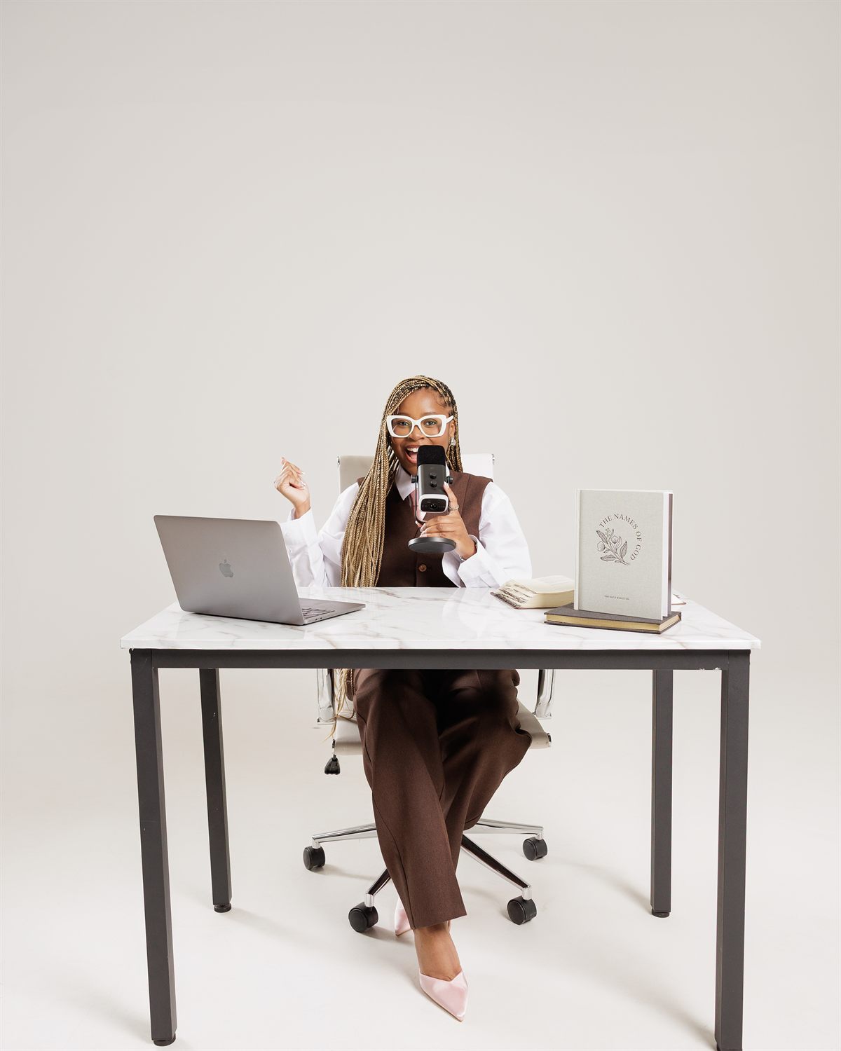 Podcaster laughing at the microphone during a personal branding session by ShotByJord