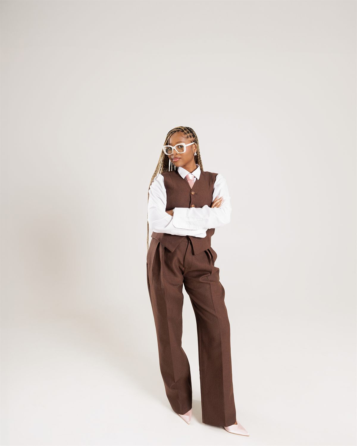 Creative professional standing in a tailored suit, personal branding session by ShotByJord