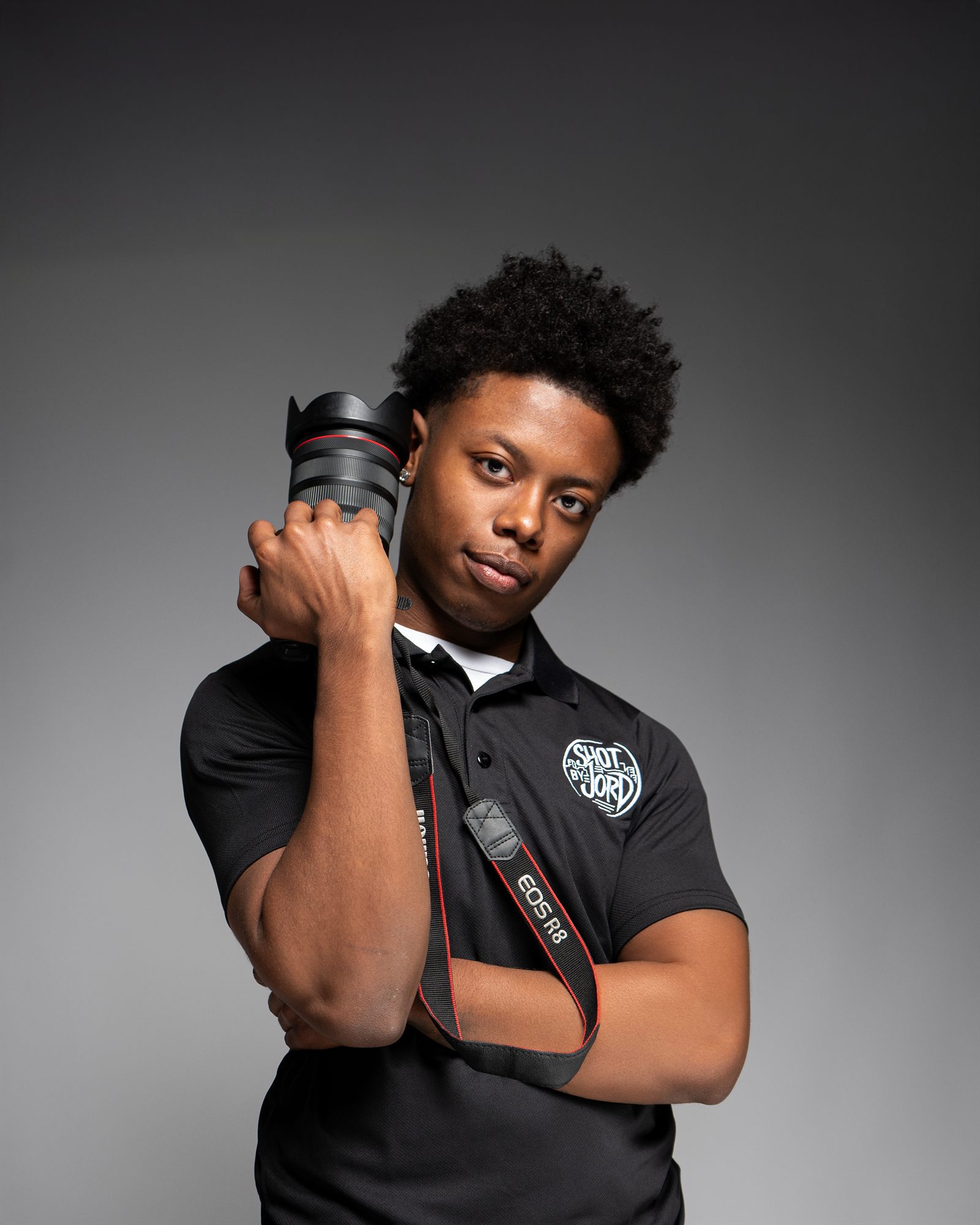 Jordan, the photographer behind ShotByJord, holding his camera